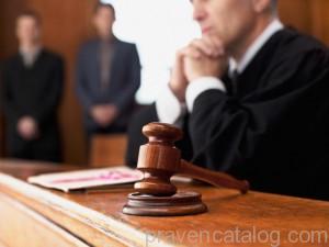 Judge and gavel in courtroom --- Image by © Ocean/Corbis